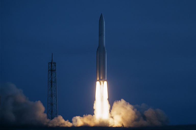Heavy rocket lifting off at dusk